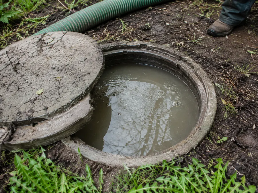Open septic tank being assessed